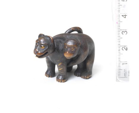 A wood netsuke of a monkey and toy tigerBy Chikusai, Edo, late 19th centuryThe toy tiger standing foursquare, facing ahead an