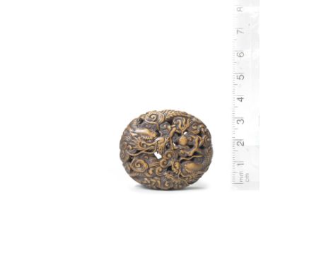 A boxwood manju netsuke of two dragons19th centuryThe netsuke of oval form, carved and pierced in Ryusa style depicting two d