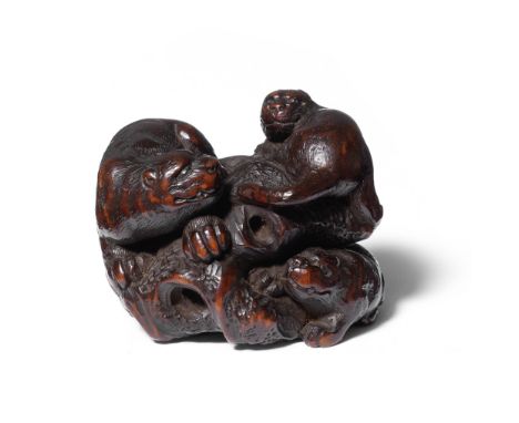A wood netsuke of a tiger and youngBy Kokei, Kuwana, Ise Province, late 18th/early 19th centuryThe parent prowling on a large