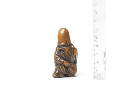 A wood netsuke of FukurokujuBy Tsuji, late 18th centuryFukurokuju in mid-stride, his face with an amused expression, holding 