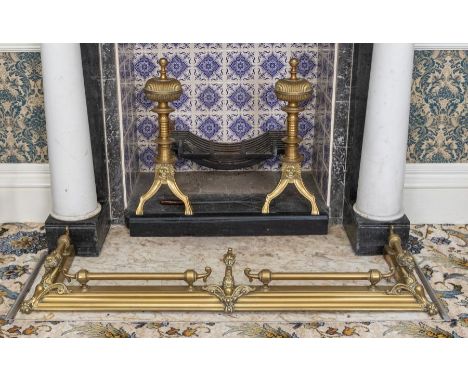 A large pair of brass andirons, Victorian circa 1880, with fluted cushion tops, fluted stems, and bifurcating legs, with asso