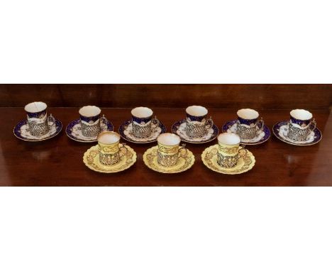 A Set of Six Coalport Coffee Cups with pin roses and blue and gilt border,  ‘5205’ (one cup cracked)  with George V silver pi