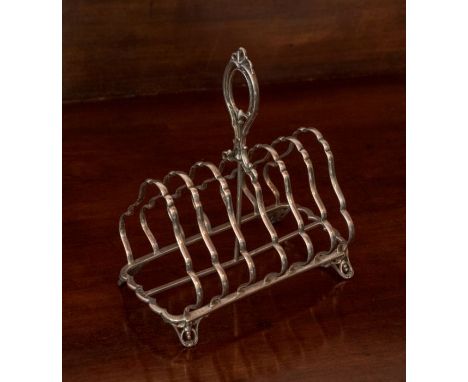 A Victorian silver seven-bar Toastrack, with pierced loop handle, raised  on four pierced scroll feet, Sheffield 1858, Henry 