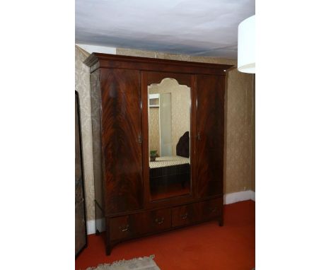 A mahogany double wardrobe, 1920’s, central mirror flanked by doors, drawers to the base, 169 cm wide   OBJECT LOCATION: THE 