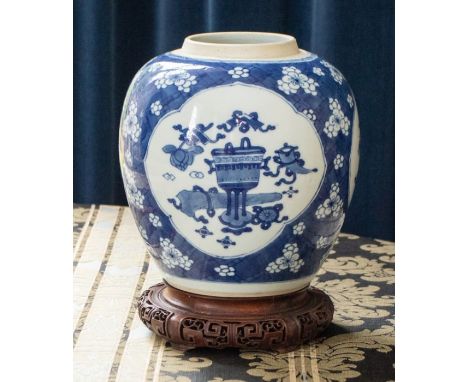 A Chinese blue and white ginger jar, Qing Dynasty, Kangxi period circa 1700, painted with two main bracketed panels of precio