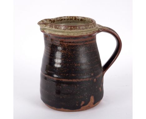 Richard Batterham (born 1936), a ribbed stoneware jug, tenmoku glaze to an ash glaze rim, 16.5cm high CONDITION REPORT: Good 