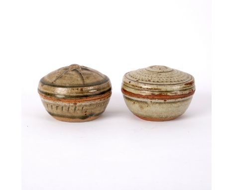 Richard Batterham (born 1936), two circular lidded stoneware boxes, green ash glaze, one with sunburst pattern to lid, the ot