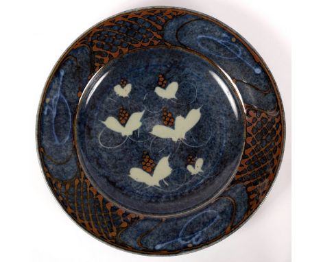 David Frith (born 1943) for Brookhouse Pottery, a stoneware charger, with painted and wax resist leaves and berries decoratio