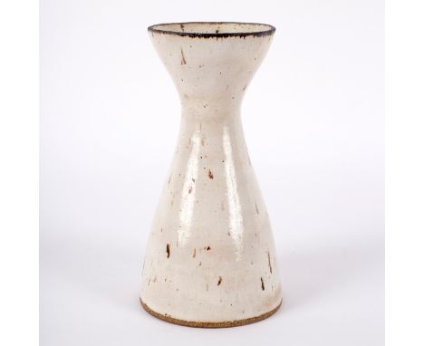 Lucie Rie (1902-1995), a stoneware vase with flaring rim, speckled white glaze, impressed seal to base, 18.5cm high/Provenanc
