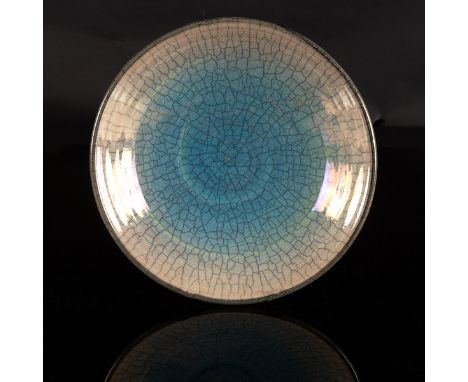 John Dunn (born 1944), a raku pottery shallow bowl, interior with graduated iridescent blue crackled glaze, painted yellow si