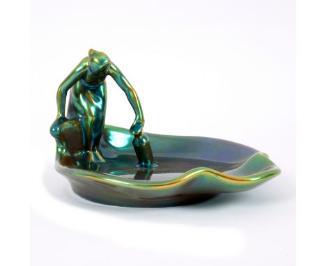 Zsolnay, an Art Nouveau dish, late 19th Century, modelled as a woman with a pail beside a lily pad, turquoise eosin lustre gl