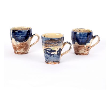 Nigel Lambert (born 1962), a set of three mugs, in blue, cream and coffee glazes, the tallest 10.5cm high [3] CONDITION REPOR