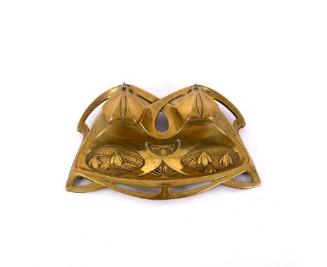 A brass inkwell in the Jugendstil style, embossed snowdrops and with flowerhead covers, one glass well, impressed no. 3631 to