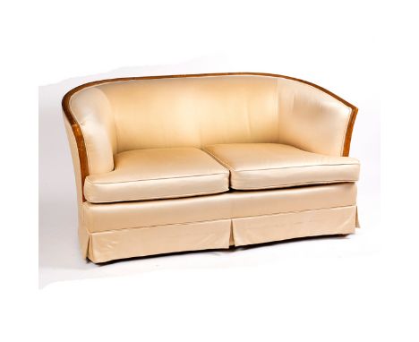 An Art Deco style sofa, with curved wood frame and cream upholstery, 148cm wide