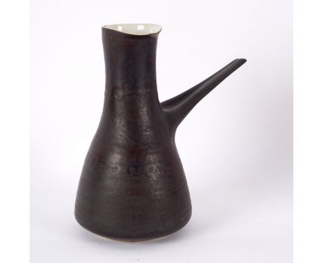 Lucie Rie (1902-1995), a coffee pot, with manganese glaze and cream interior, elongated handle, impressed mark, 22cm high (ri