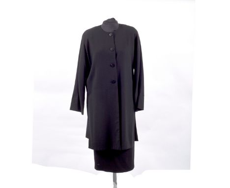 A Jean Muir black wool crepe suit, the half placket front jacket with round neck and side slits, UK Size 12 with matching pen