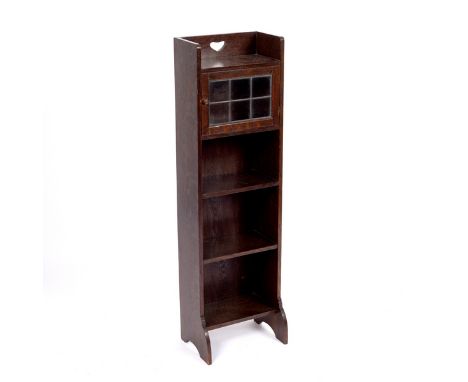 Liberty, a narrow Art Nouveau style bookcase, the galleried top with pierced heart motif above a leaded glazed cupboard with 