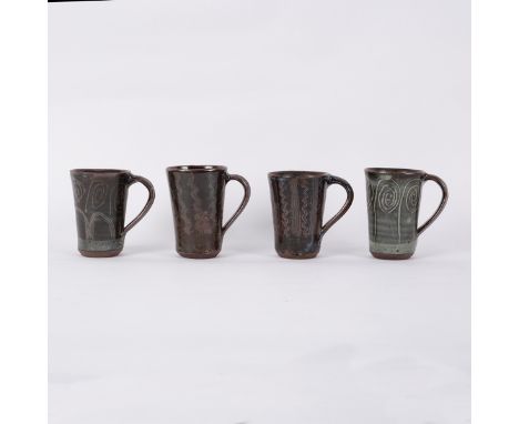 Ladi Kwali (c.1925-1984), four stoneware mugs, tenmoku and ash glazes with incised patterns, all with impressed mark, 13cm hi