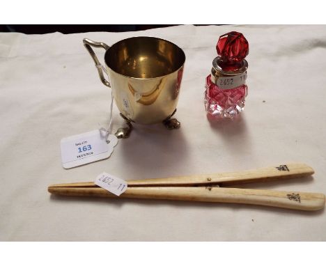 A pair of ivory glove stretchers, silver plated three-footed beaker and a ruby glass perfume bottle