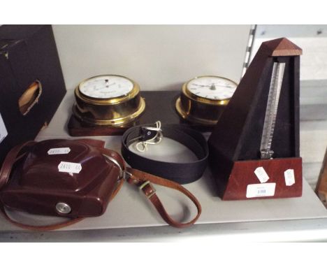 A clock and barometer, a metronome and a camera