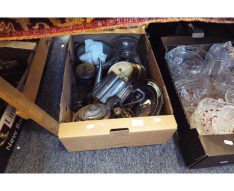 A box of assorted silver plate, pair of brass candlesticks and a barometer