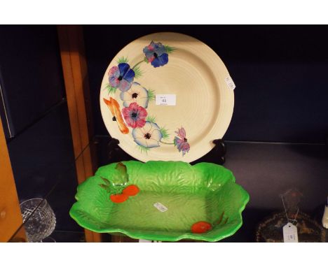 A Clarice Cliff plate and a Carlton ware leaf plate