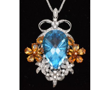 Topaz and diamond pendant, the fancy pear-cut blue topaz flanked by orange topaz stones in floral mount, diamond set flowers 