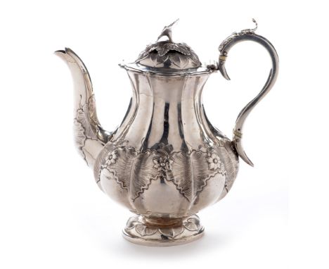 A William IV silver teapot , by William Hewitt, London 1834, of baluster form with flower pattern finial, above leaf decorate