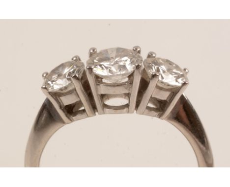 A three stone diamond ring, the slightly graduated brilliant-cut diamonds weighing a total of 1.70 carats, on 18ct white gold