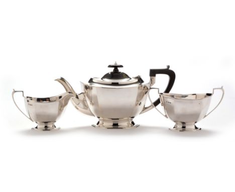 A George VI silver three-piece tea service, by Northern Goldsmiths Co, Sheffield 1939, octagonal form, teapot with ebonised h