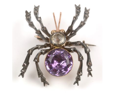 A Victorian spider brooch, the body set with circular facet cut amethyst and white paste stones, the white metal legs set wit