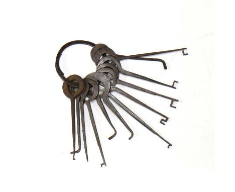 LARCENY,18th century, English, a set of thief's tools, with twelve various wrought iron picks and key shapes on a wrought iro