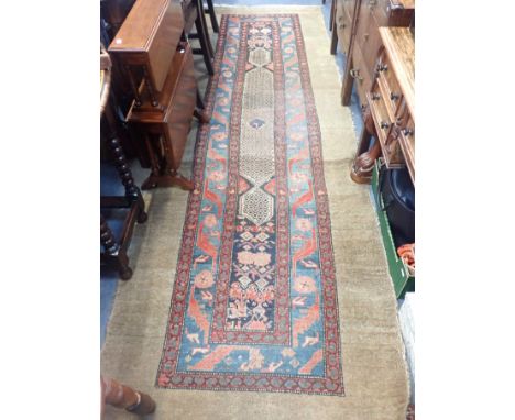 A CARPET RUNNER, WITH MOTIFS WITH REPEAT BORDERSwithin a broad plain border 105 x 306cm plus fringes (moth damage, dirty)