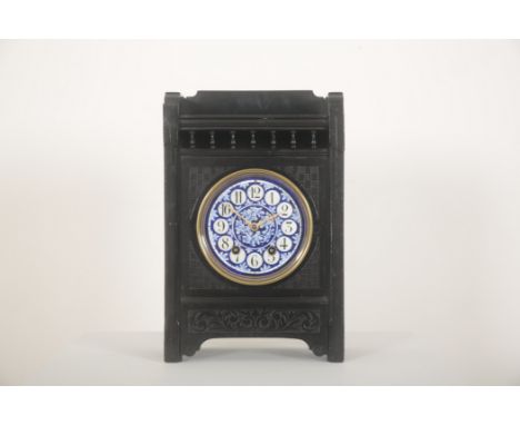 A LATE 19TH CENTURY EBONISED MANTEL CLOCK OF AESTHETIC DESIGNthe blue and white pottery dial possibly by Wedgwood with Arabic