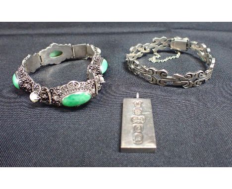 A JADE BRACELETin sterling silver, set with four jade cabochons, alternating with pearls over a scrolled design: together wit