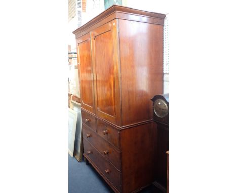 A GEORGE IV MAHOGANY LINEN PRESSthe upper part with angled cornice, now fitted hanging rail and shelf slats, enclosed by a pa