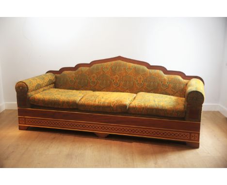 A HARDWOOD THREE-SEATER SOFA WITH ARCHED MORESQUE BACK RAILSmodern, upholstered throughout in arabesque patterned fabric high