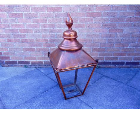 A VICTORIAN COPPER STREET LAMP FITTING  of square tapering form with hinged door, cylindrical funnel and finial, lacking glas