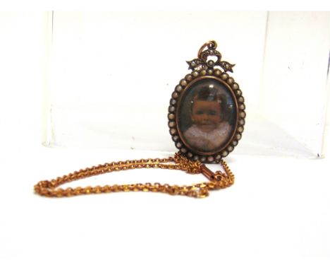 A MURLE BENNETT & CO DOUBLE SIDED PICTURE PENDANT  stamped marks, with seed pearl set oval frame and ribbon bow surmount, on 