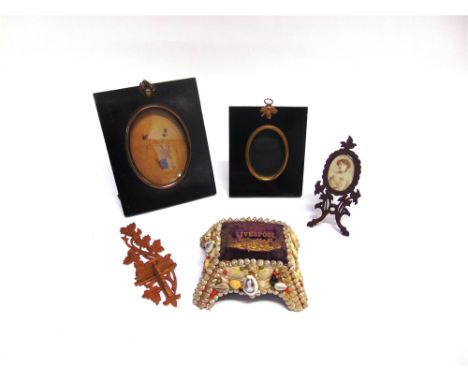 TWO SILHOUETTE PICTURE FRAMES together with a small fretwork easel-back photograph frame; a small fretwork wall bracket; and 
