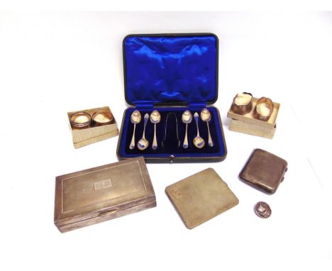 A CASED SET OF SIX SILVER TEASPOONS WITH TONGS two silver cigarette cases; a silver vesta case; a pair of silver napkin rings