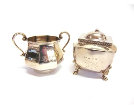 A SILVER TEA CADDY maker C.H., Birmingham 1899, of rectangular outline, on lion paw supports, monogrammed; with a silver suga