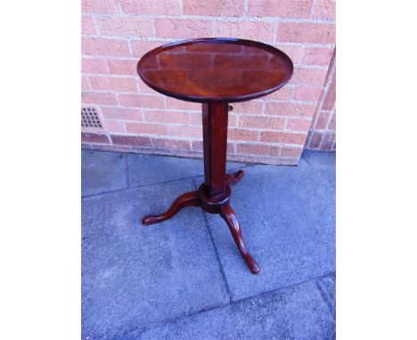 AN ADJUSTABLE MAHOGANY OCCASIONAL TABLE/STAND  the circular tray top 39cm diameter, on brass mounted square pillar and tripod