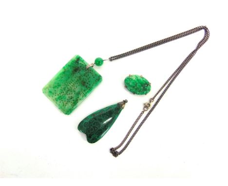 A JADE PANEL PENDANT pierced and carved with confronting dragons and a character, the bale set with four single cut diamonds 