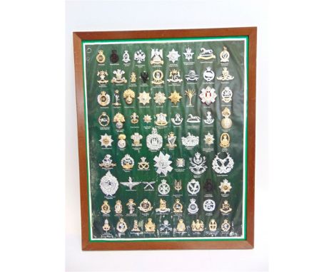 A FRAMED DISPLAY OF BRITISH ARMY STAYBRITE CAP BADGES (77).