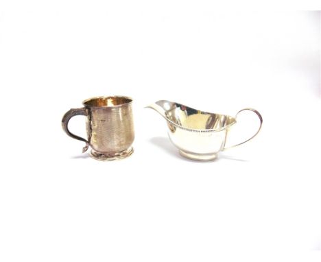A SILVER SAUCEBOAT Sheffield 1936, of plain form; and a silver christening mug with engine turned decoration, Birmingham 1926
