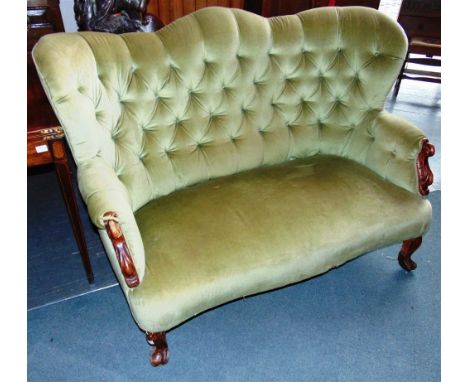 A BUTTON UPHOLSTERED CARVED MAHOGANY FRAMED SOFA  with shaped back and carved arms, supported on cabriole supports, 150cm wid