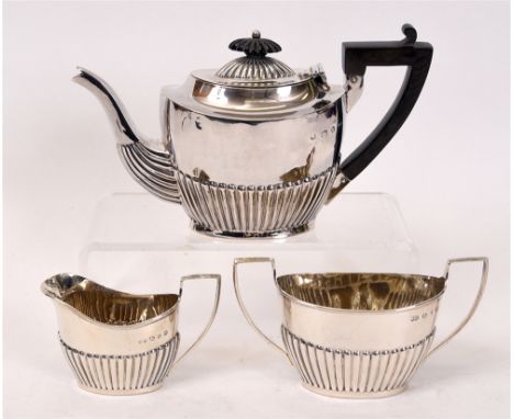 A LATE VICTORIAN THREE PIECE SILVER BACHELOR TEA SERVICE  by Nathan and Hayes, Birmingham 1895, of oval gadrooned form, 388g 
