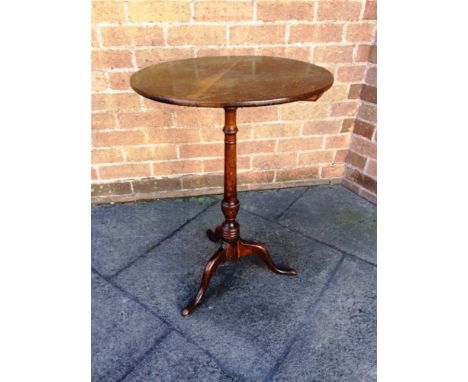 AN OAK TRIPOD OCCASIONAL TABLE,  the circular top 47cm diameter, 68cm high overall