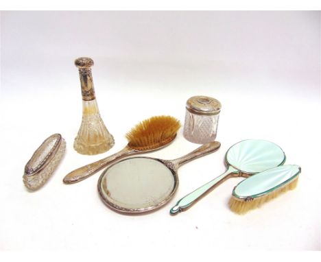 A COLLECTION OF SILVER DRESSING TABLE ITEMS comprising an enamel hand mirror and matching clothes brush; a silver hand mirror